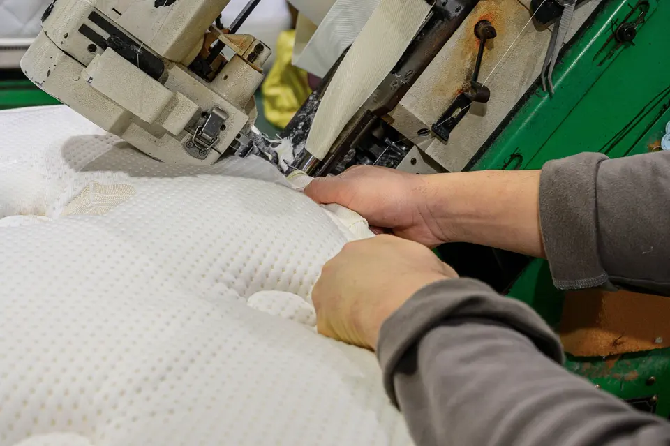 Stacked foam mattress layers being prepared on the TFM production line